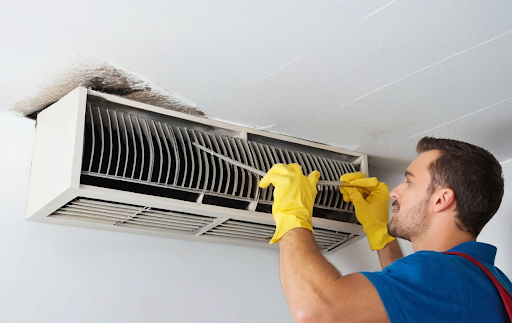 Guy cleaning AC